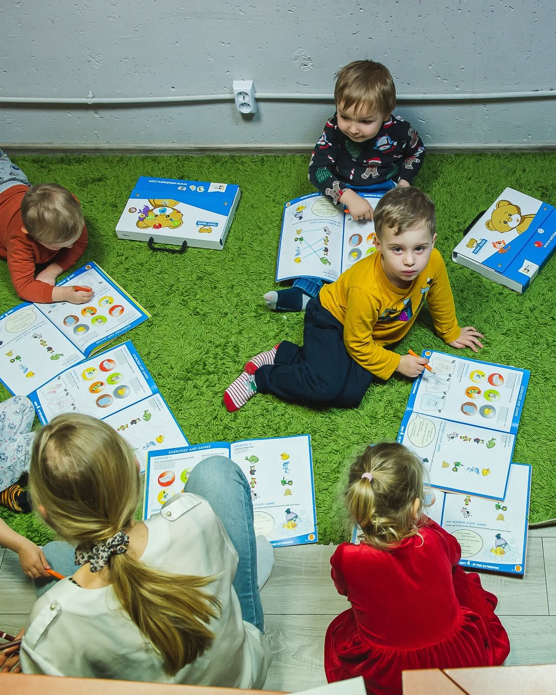 nauka angielskiego od najmłodszych lat w małej grupie, dzieci siedzą w kręgu z materiałami Teddy Eddie